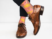 Yellow crew socks with a chrysanthemum pattern, shown flat.